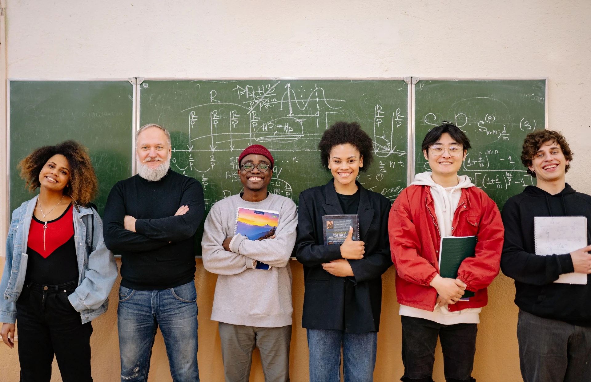 Group of learners standing in front of a chalkboard